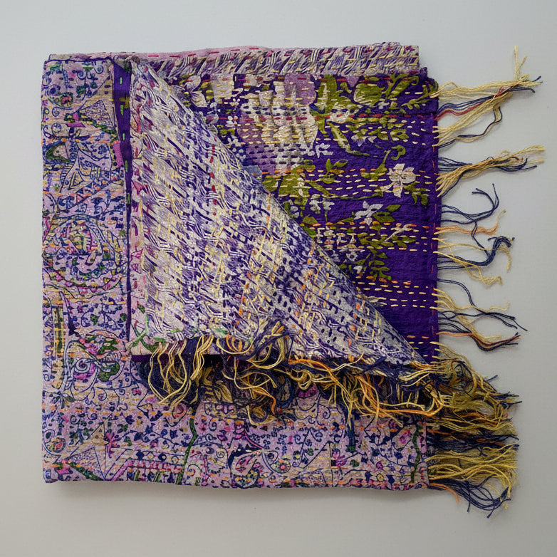 A purple silk sari scarf with floral patterns and kantha stitching, displayed on a neutral background.