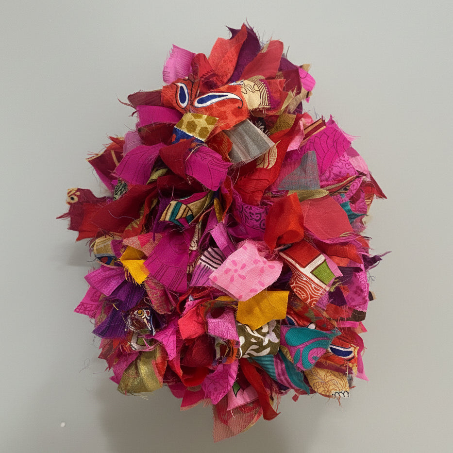 Colorful fabric ball on a textured gre background