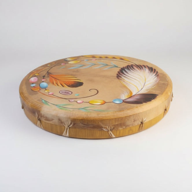 Decorative wooden plate with painted feathers and flowers on a white background