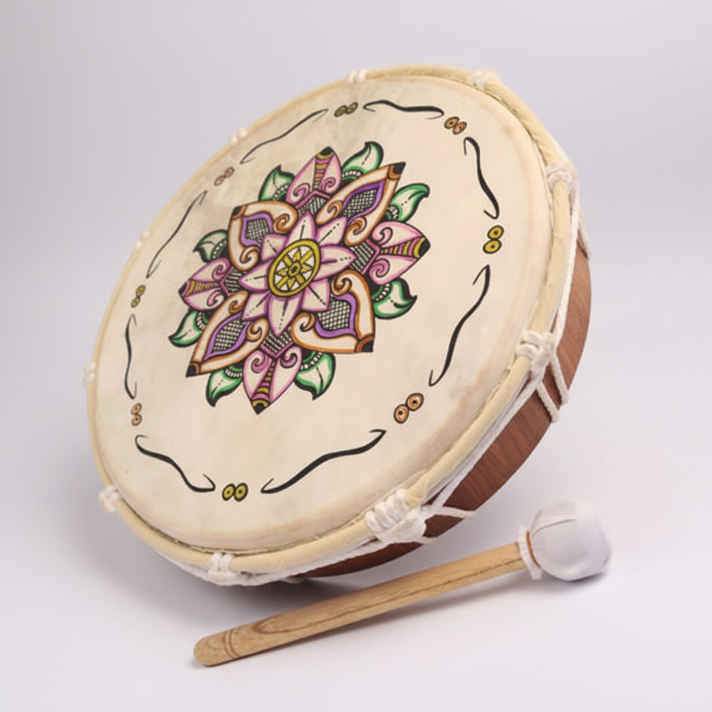 Decorative drum with mandala design and mallet on a white background