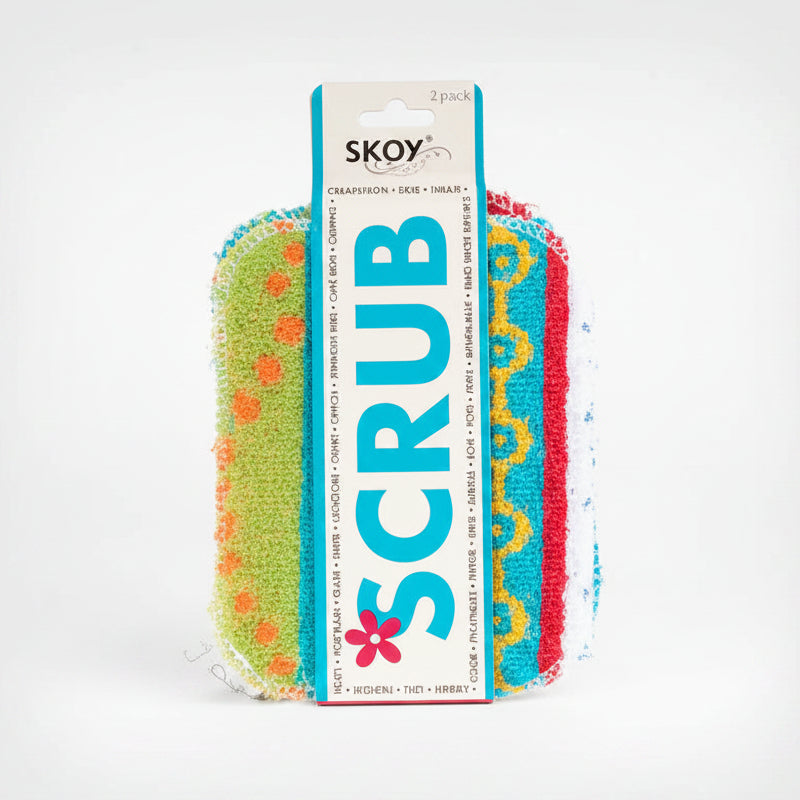 A pack of two colorful scrubber pads wrapped in a white cardboard sleeve labeled 'SKOY SCRUB'. The scrubbers are lime green with orange dots, turquoise blue with yellow swirls, and red with yellow swirls.