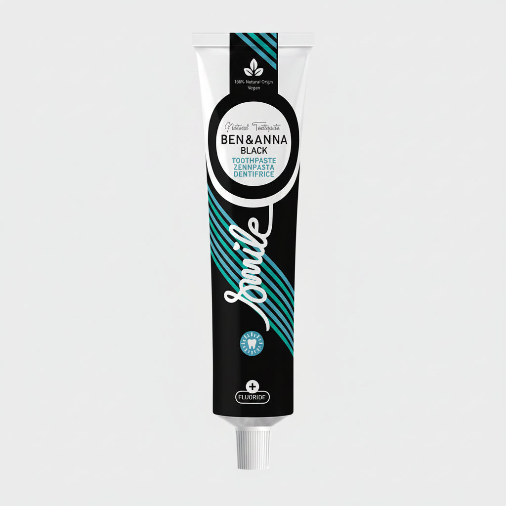 A tube of  Ben & Anna Smile toothpaste with a black, blue, and white color scheme, indicating it is vegan and contains fluoride.