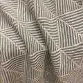 Close-up of a woven textile with a geometric basketweave pattern in taupe and gray.