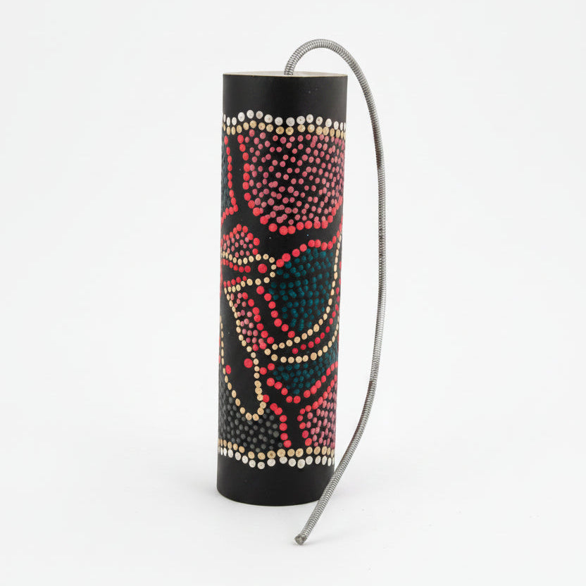 Thunder drum painted with colourful dots a spring attached to one end
