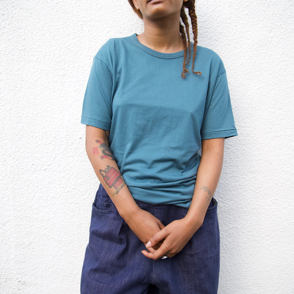 a women wearing an olive t shirt