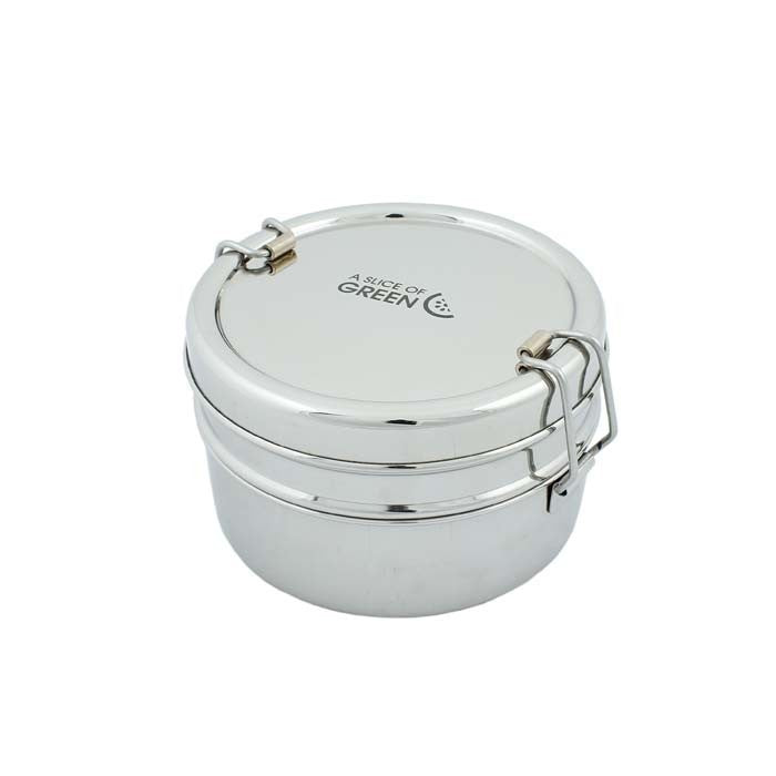 A stainless steel two-tier lunch box with a lid and handle. featuring the brand Green Pioneer on the top.