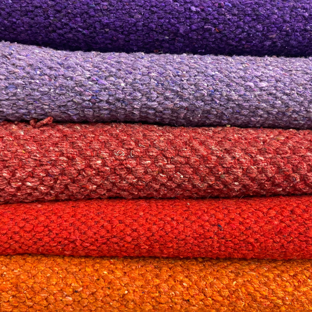 pile of brightly coloured cotton rugs