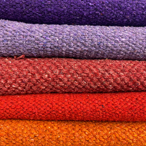 pile of brightly coloured cotton rugs