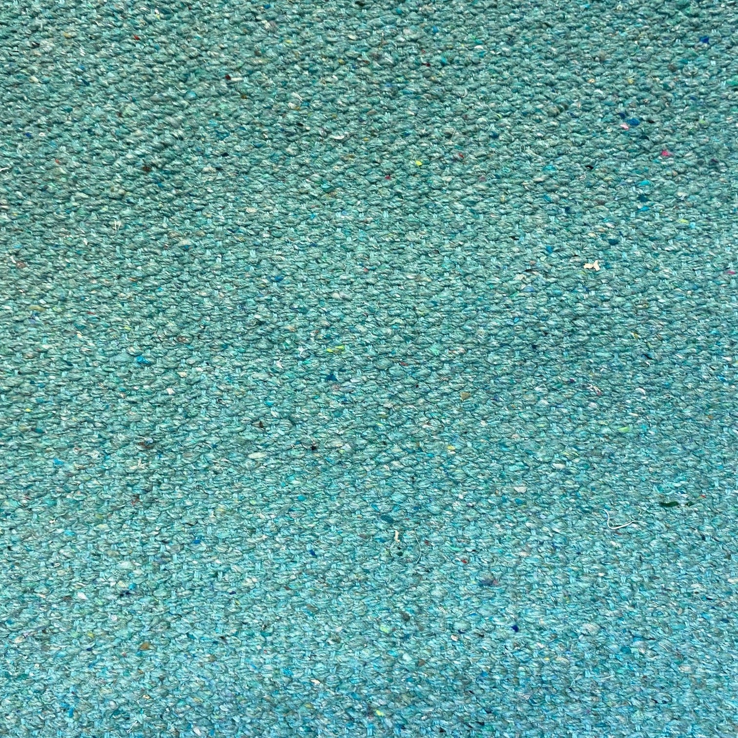 Close-up of forest green textured rug