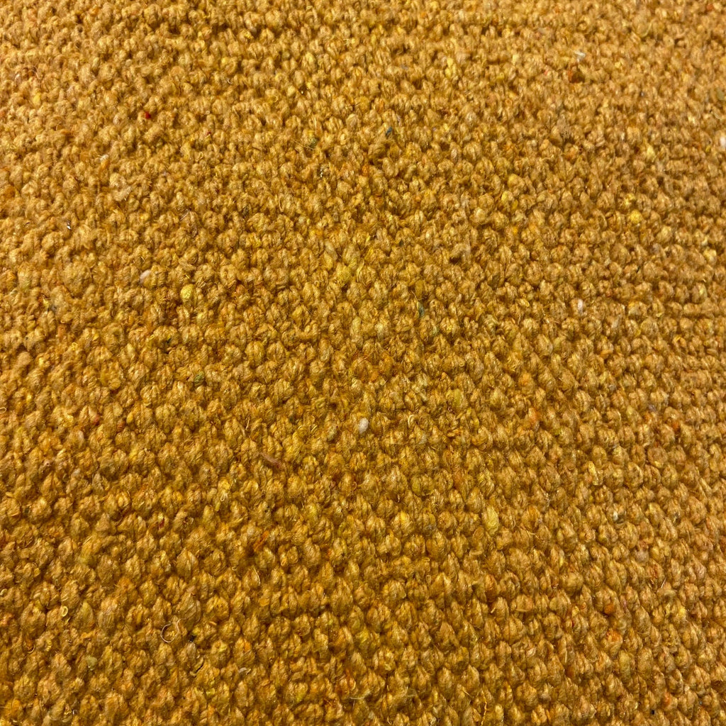 Close-up of gold textured rug