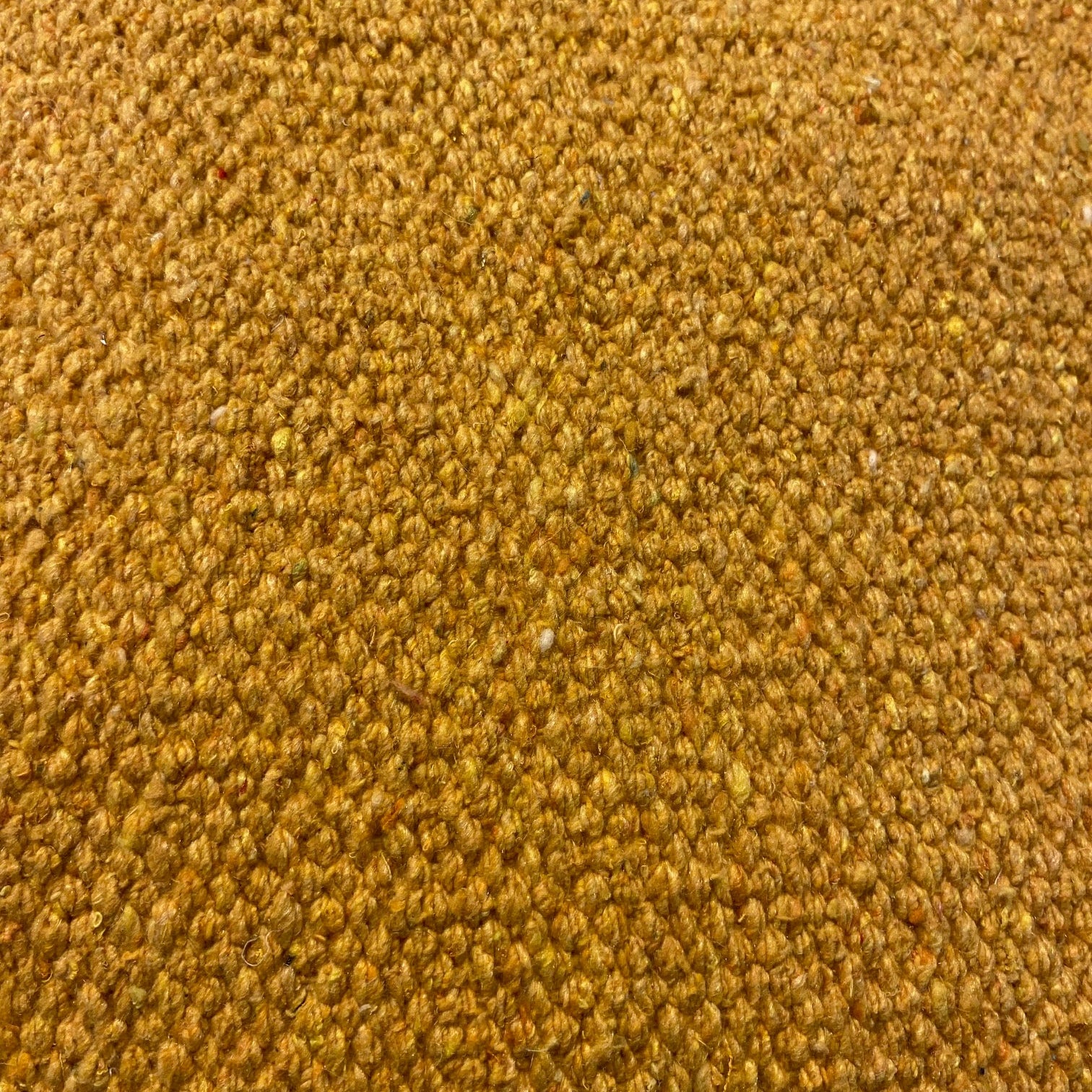 Close-up of gold textured rug