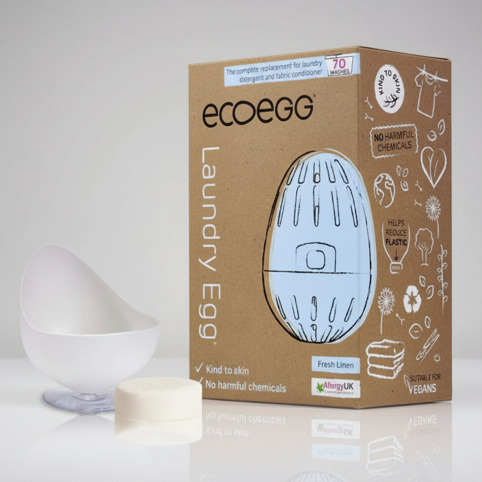 A white laundry egg next to its packaging box, which is adorned with eco-friendly icons and states 'No harmful chemicals', indicating the product is laundry-related and likely environmentally friendly.