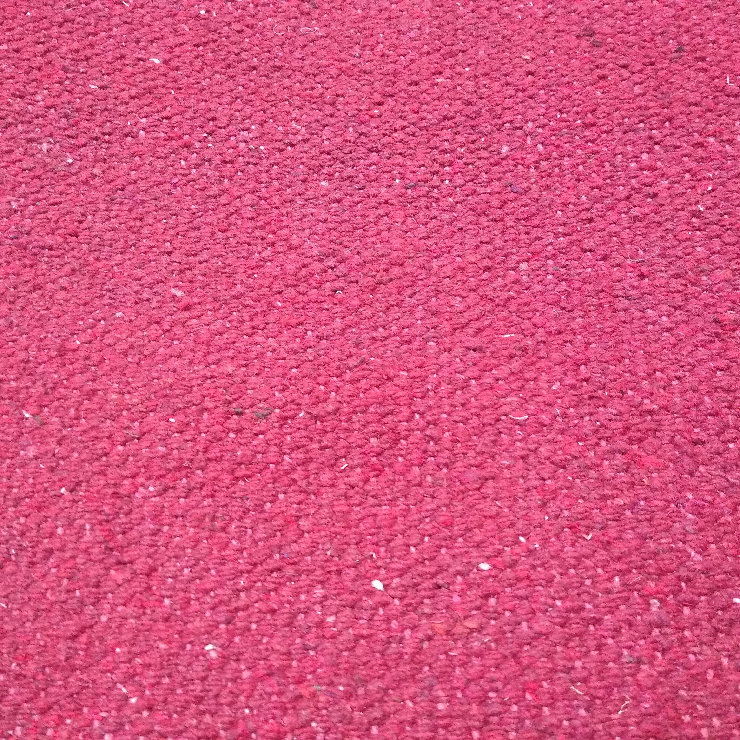 Close-up of magenta textured rug