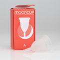 A Mooncup menstrual cup in white color, displayed next to its orange packaging with the brand name and size 'A' indicated.
