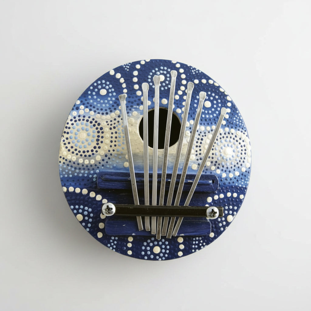 A colorful thumb piano with metal tines and a blue patterned surface.