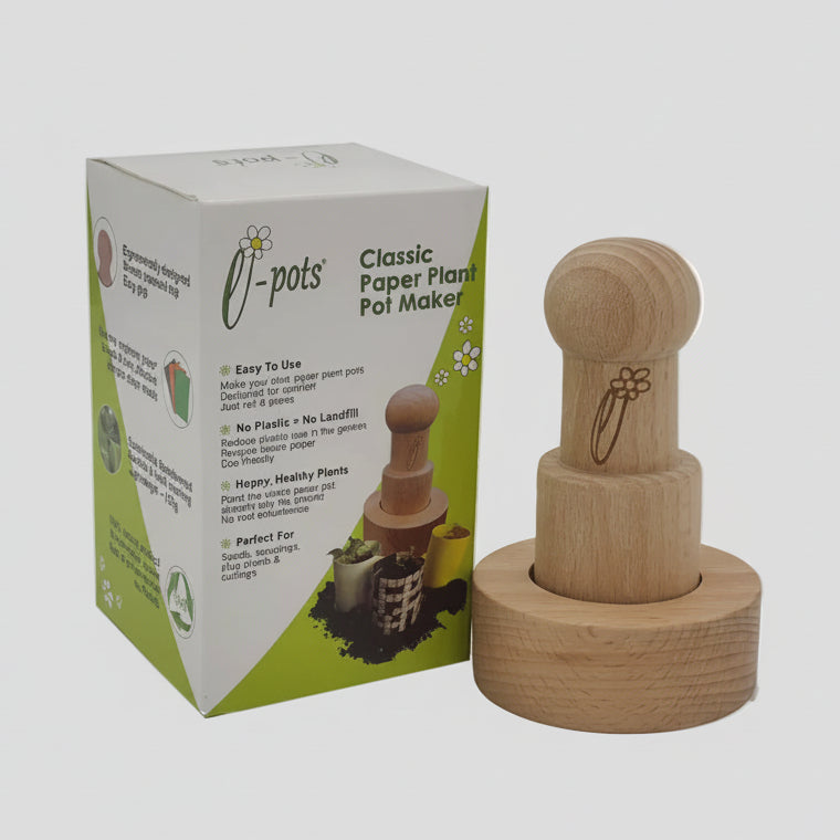 A wooden classic paper pot maker stamp alongside its white and green product packaging box, set against a plain light gray background.