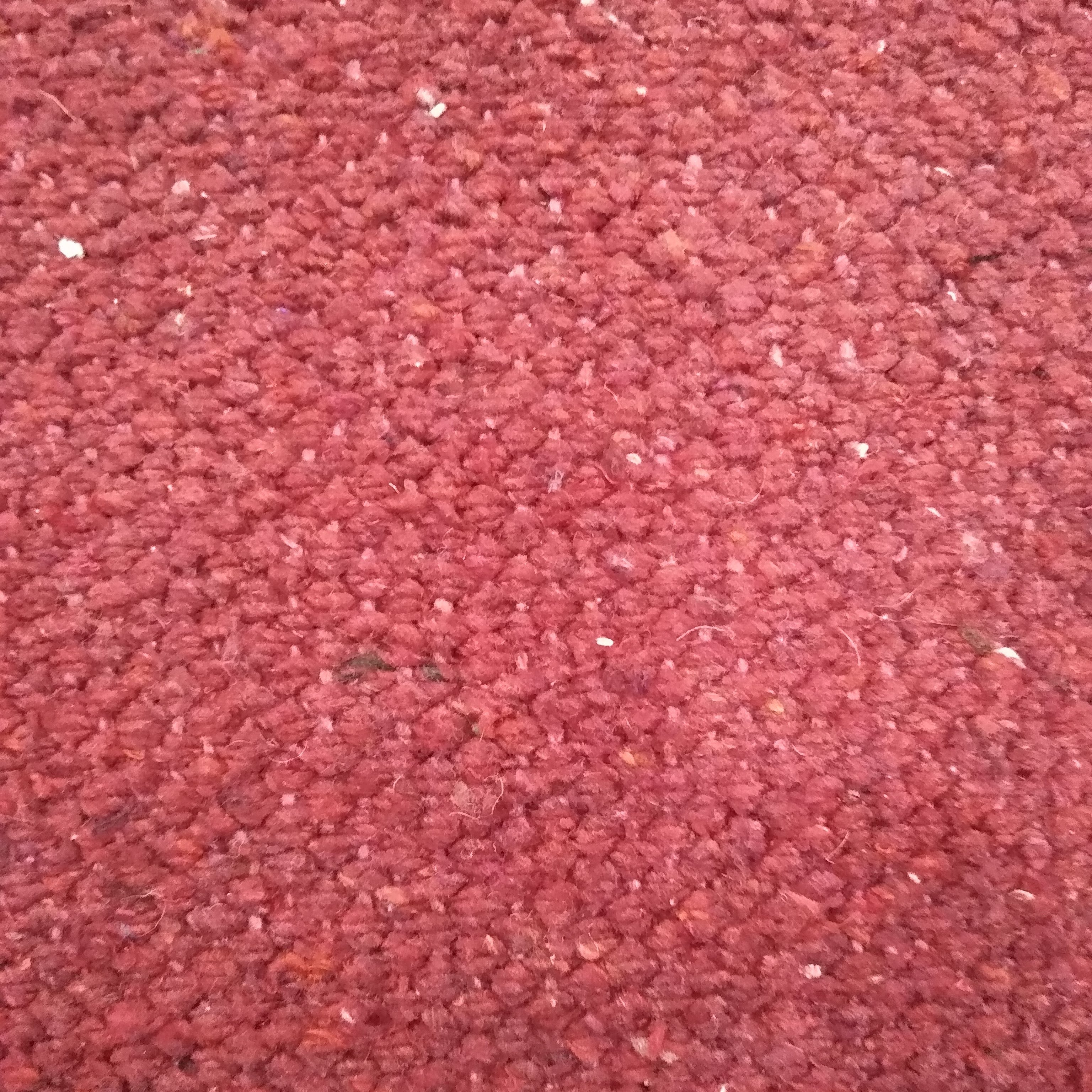 Close-up of red textured rug