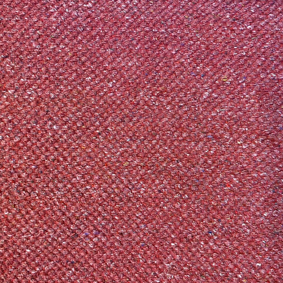 Close-up of red textured rug